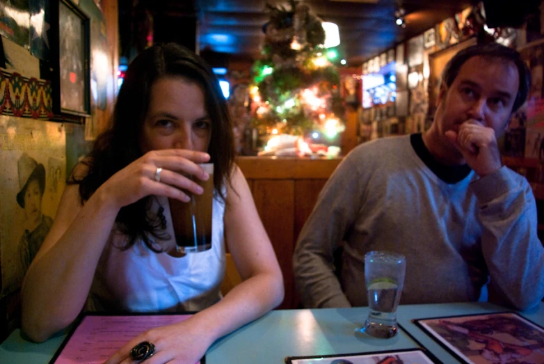 a man and woman sitting at a table in a restaurant