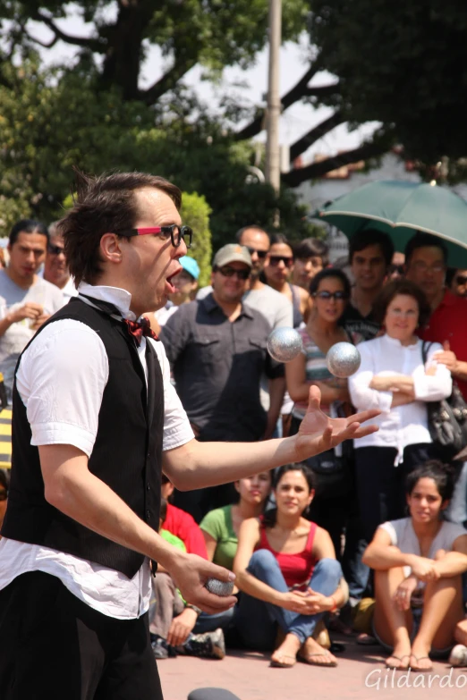 the man is juggling his hand with a ball