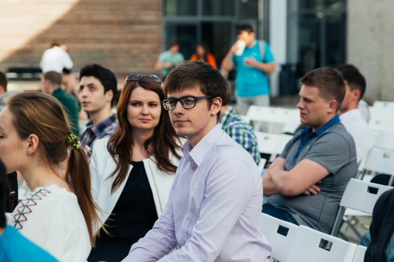 a group of people sit on the ground