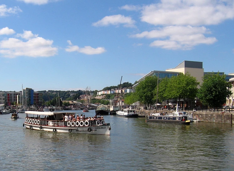 several boaters moving along a waterway with a sky background