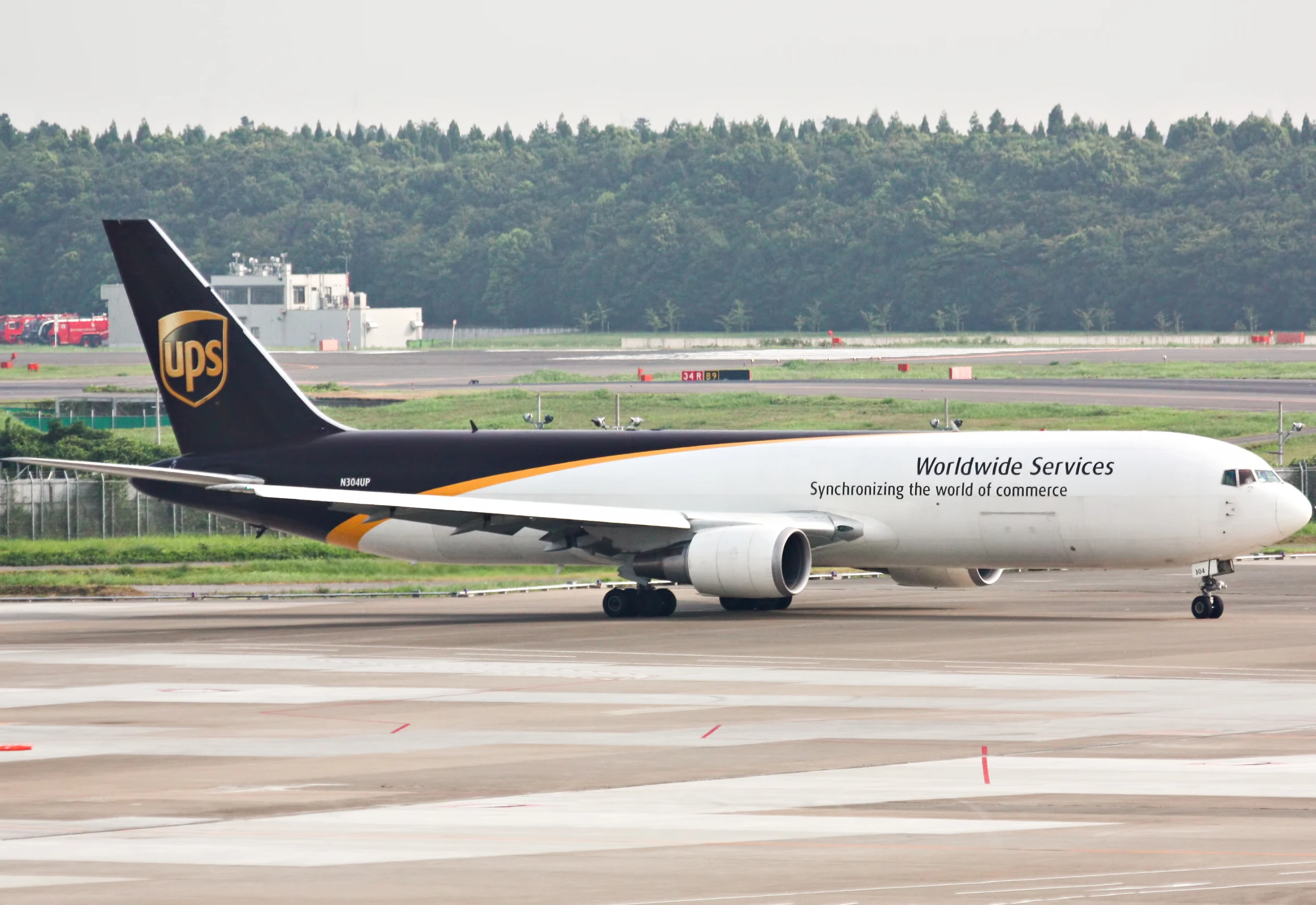 a black and white jet airliner with a yellow arrow on it