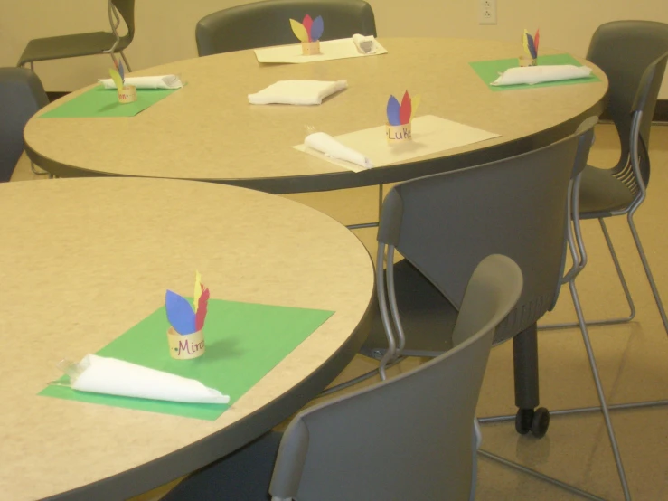 a room filled with tables and chairs topped with paper