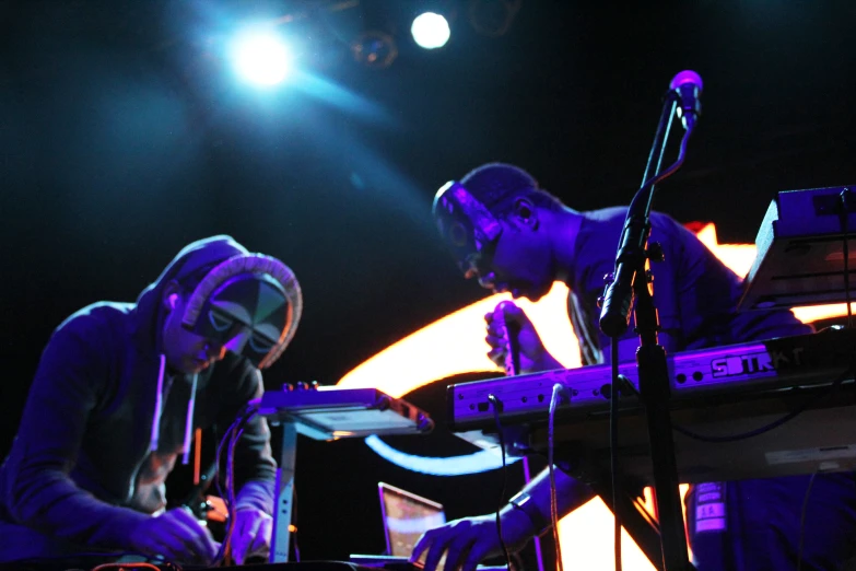 two men with a keyboard on stage