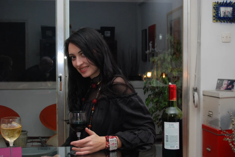 a woman is holding a glass of wine