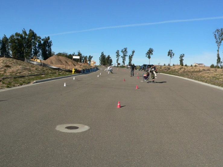 a number of people skating on a road
