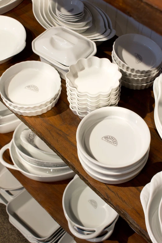 a table of white dishes and plates on top of it