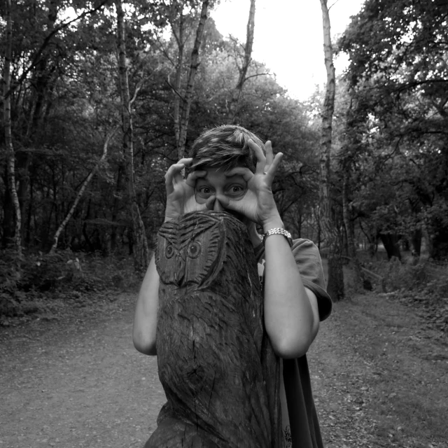 a woman with her head resting on a tree