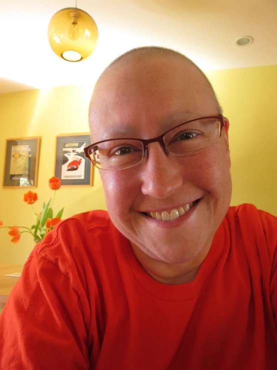 man smiling while wearing glasses at the table