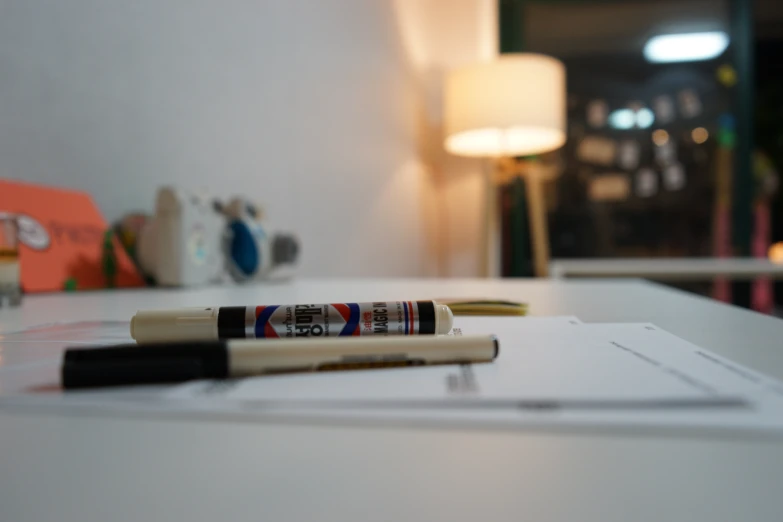 a close up of a pen sitting on top of a desk