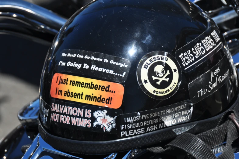 a black motorcycle helmet with stickers is shown