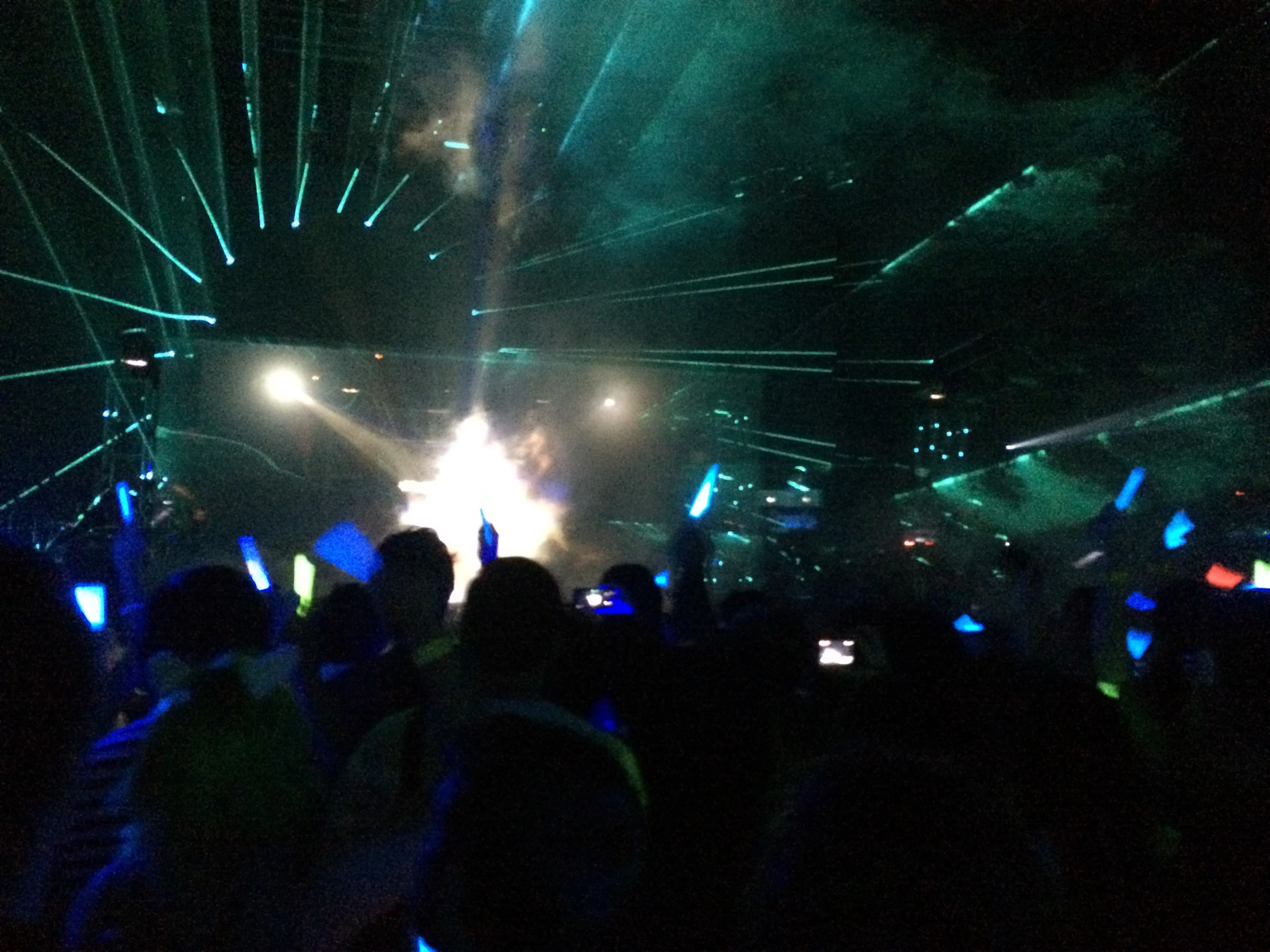 stage lighting shining brightly over an auditorium crowd