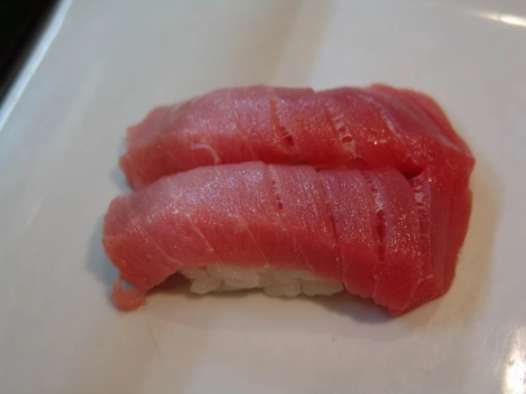 a close up of tuna pieces on a plate