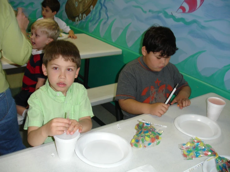 three s sitting at a table in a restaurant