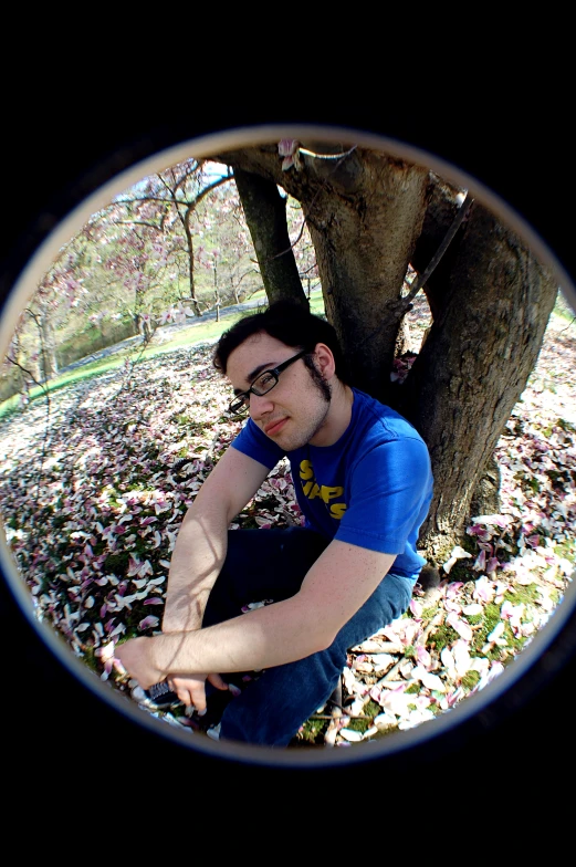 this man looks out from beneath a tree