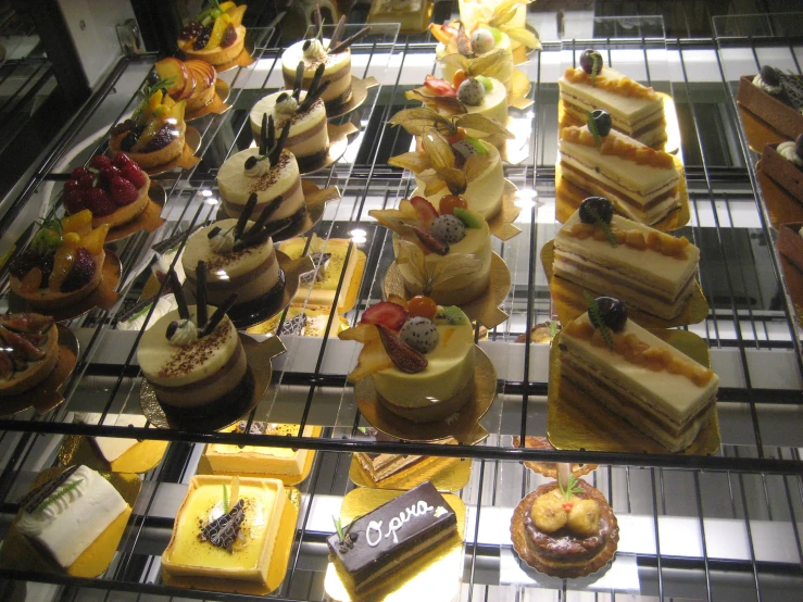 a glass tray covered in cakes on display