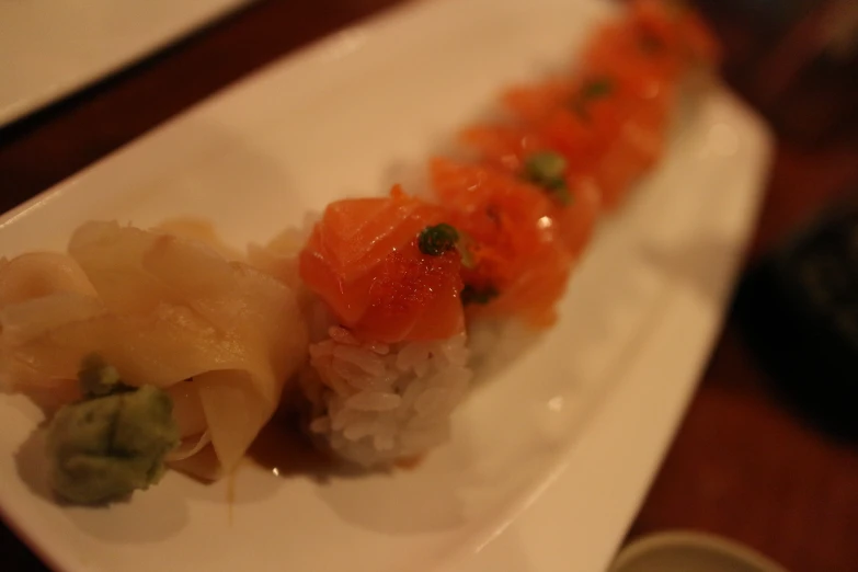 a sushi and another appetizer on a white plate