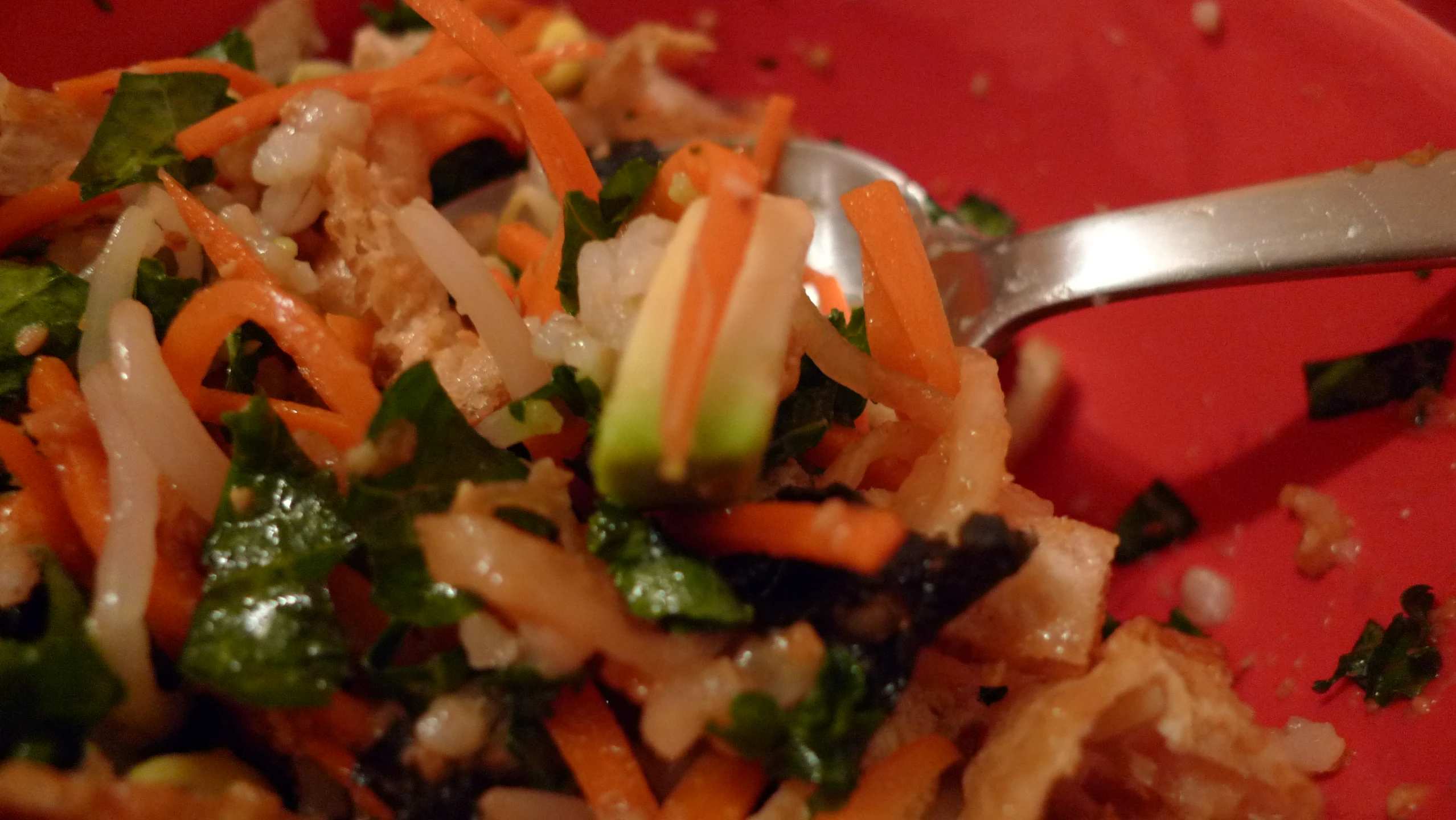 a red bowl filled with veggies and rice