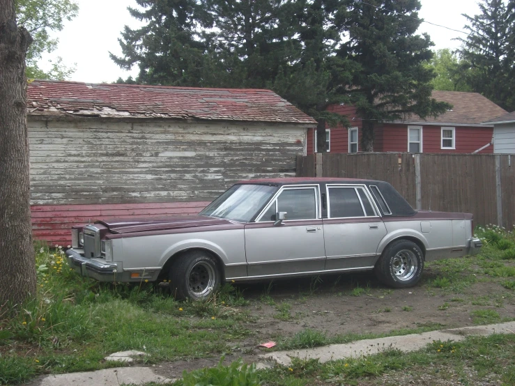 the old station wagon has a red top on it's hood