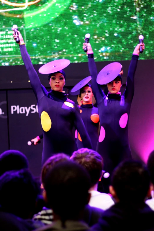 a group of dancers in costumes with hats