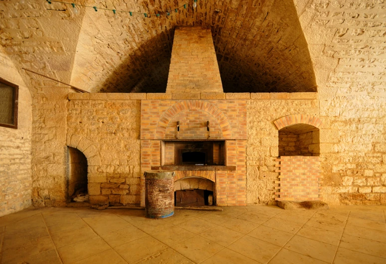 the room has stone wall, an open brick door, and a fireplace