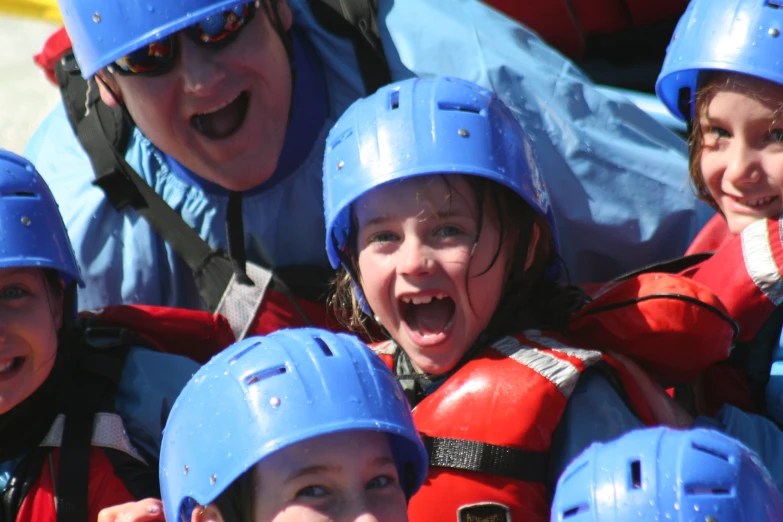 some people with helmets are smiling for the camera