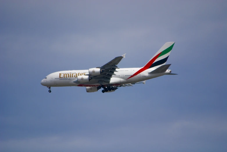 a large passenger jet flying through a cloudy blue sky