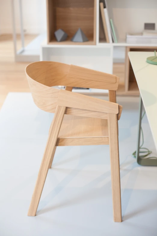 a modern chair with wooden legs and seat that appears to be bent