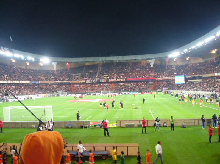 an empty stadium during a soccer match at night