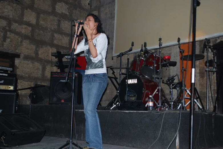 a woman singing in front of a band