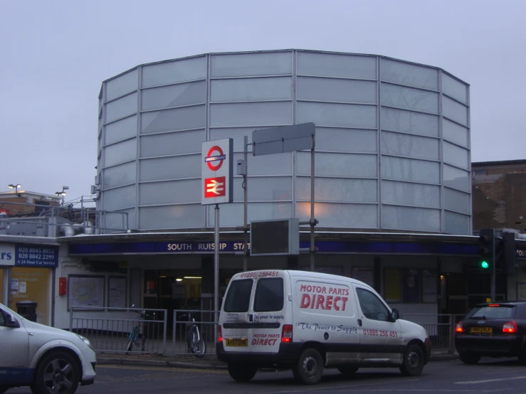 a commercial building with cars parked near it