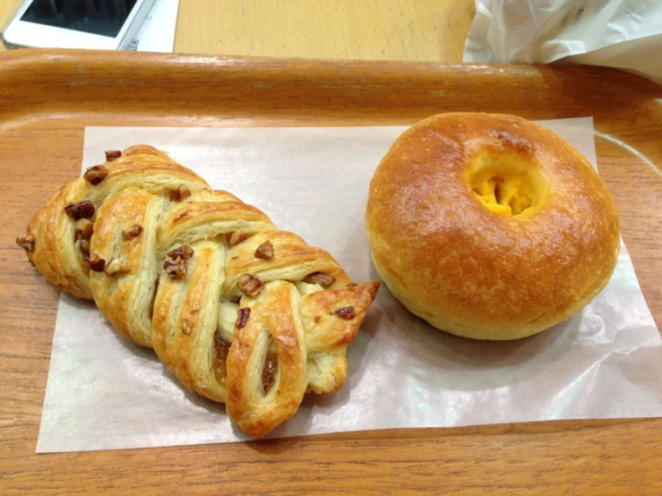 there is a pastry and one pretzel on this counter