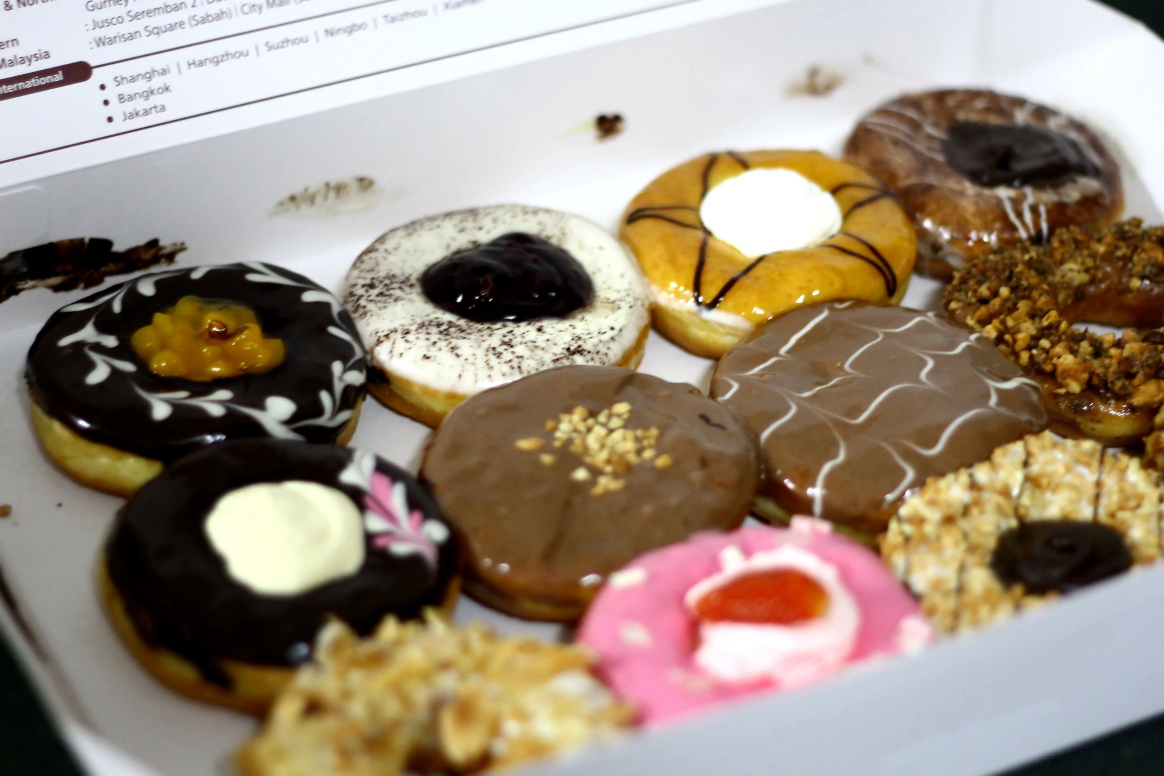 a box of decorated doughnuts is displayed on a table