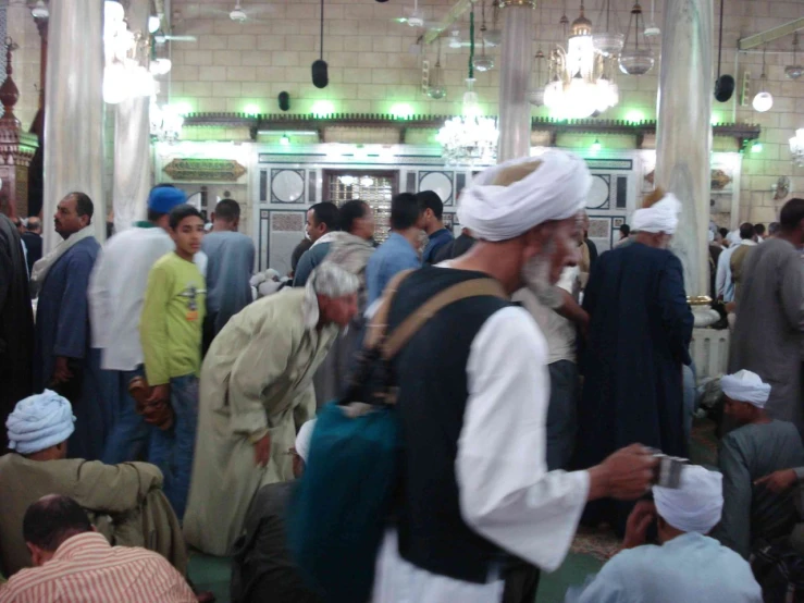 the men are standing in the hall in a crowd