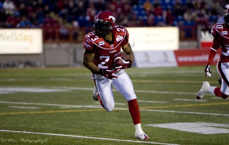 football player running for the ball in a game