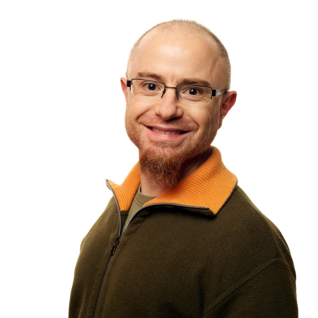 an image of man with bald hair and glasses smiling
