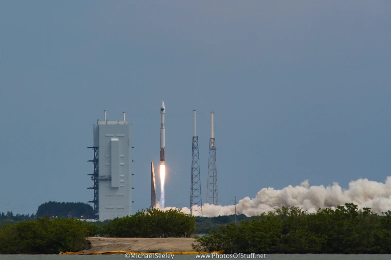 two rockets launch with smoke billowing from them