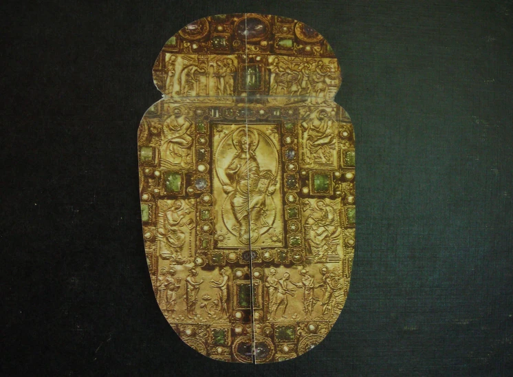 a decorative gold item on a green background