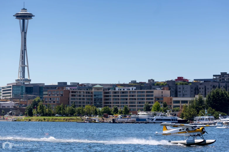 a helicopter hovers near the skyline on the water