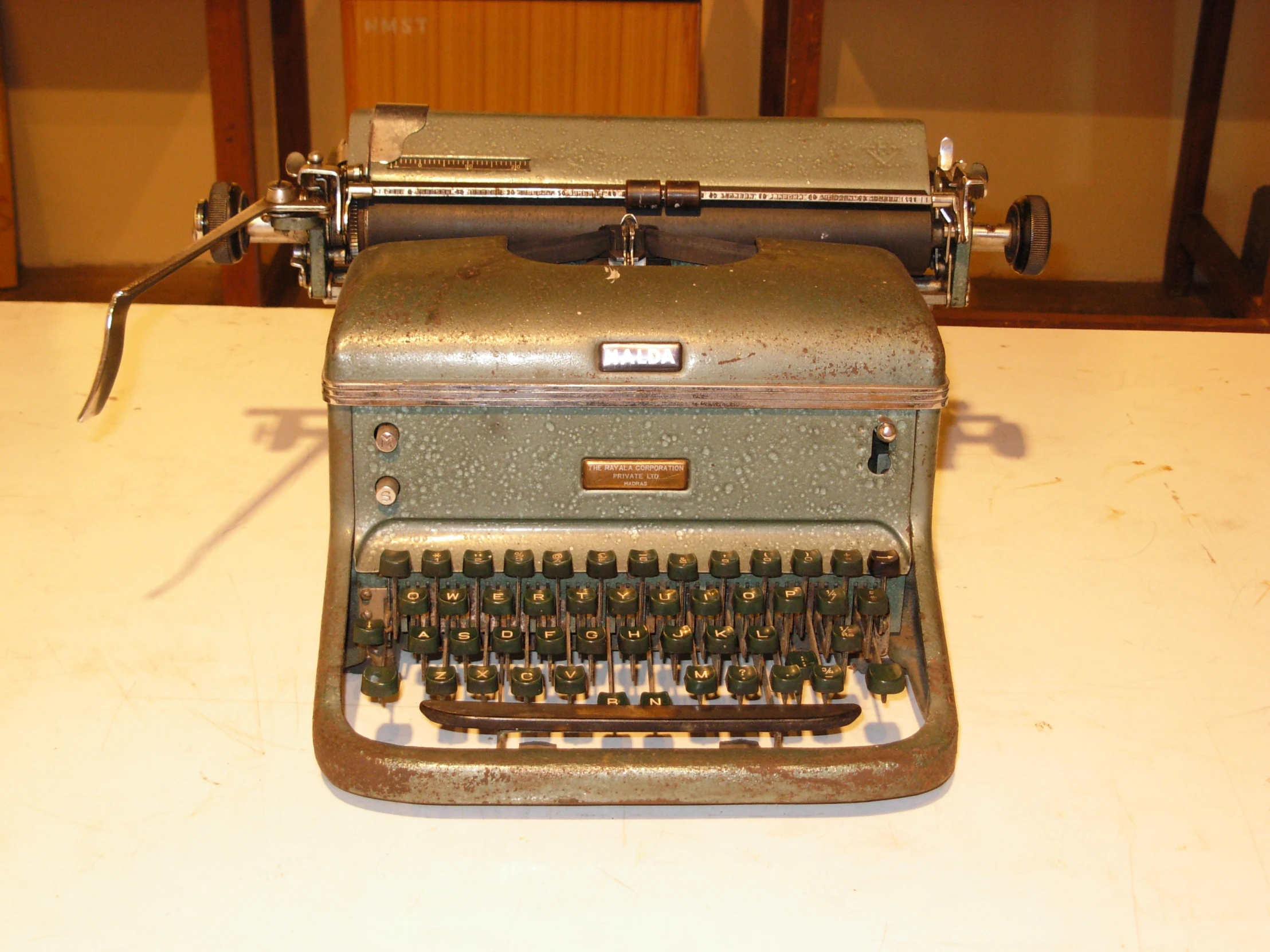 a very old typewriter sitting on a table