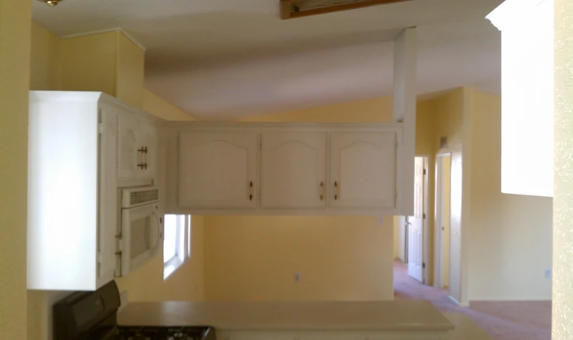 view of a kitchen from the doorway of a room that has yellow walls