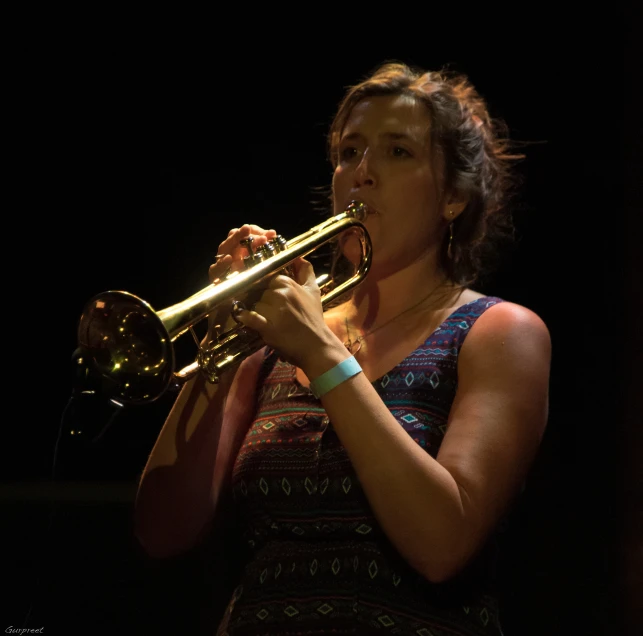 a woman in black dress holding up a ss instrument