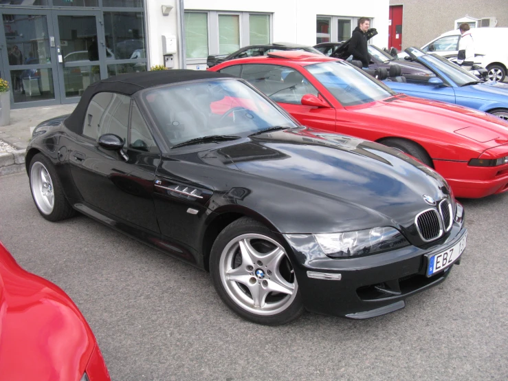 two black bmw cars, one black and one red