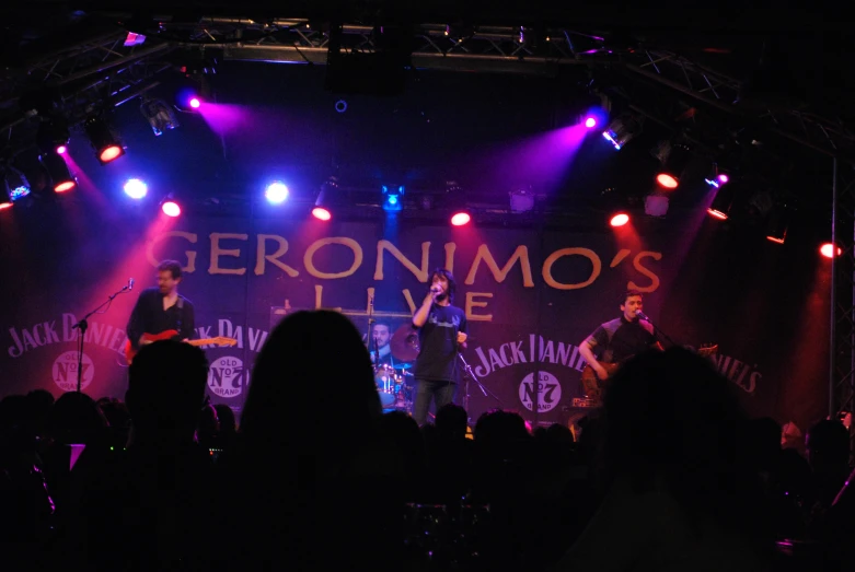 a man playing guitar at an underground concert