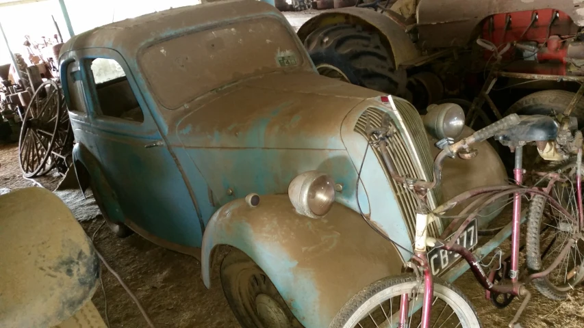 an old car is parked in a garage