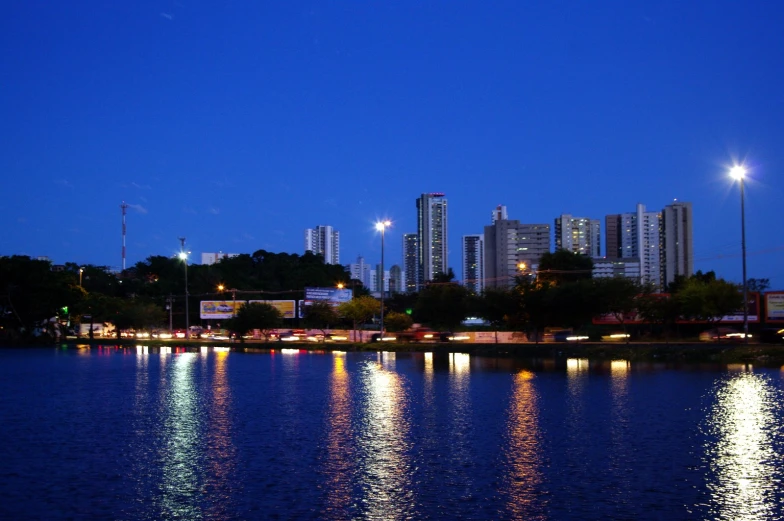 a city lit up at night over a lake