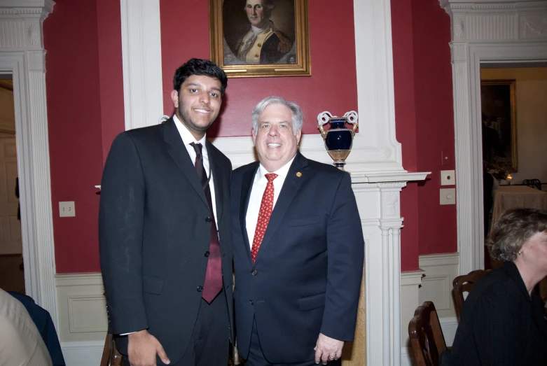 a couple of men in business suits standing next to each other