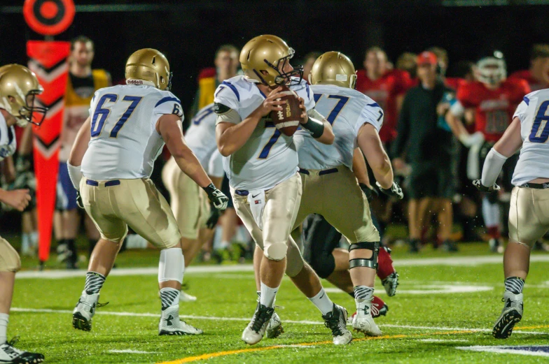 a football game with the team running on the field