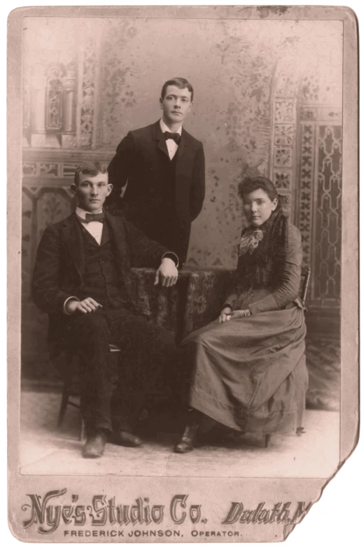 a very young family posing for a portrait in a old po