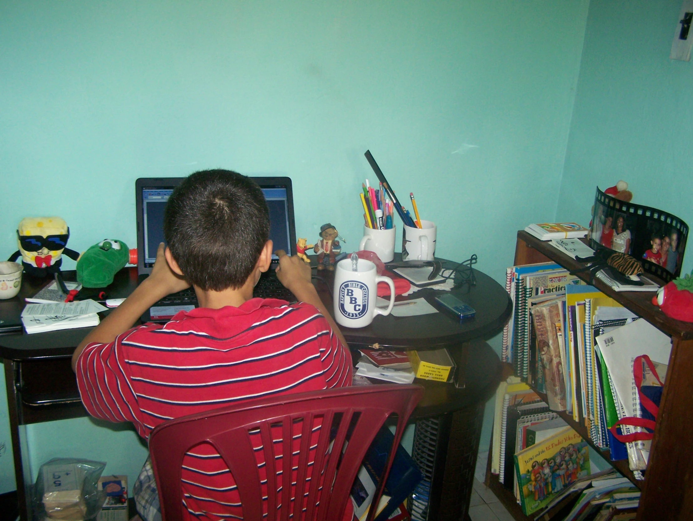 a  sitting in front of a laptop computer