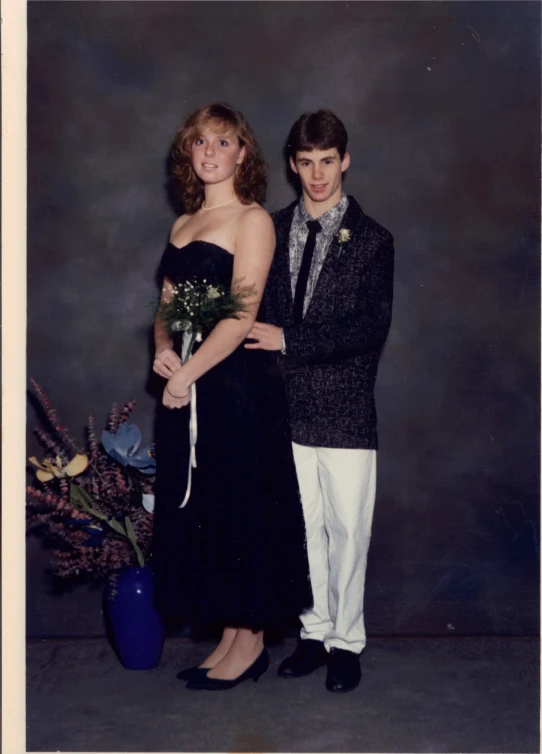 a young man and woman standing next to each other